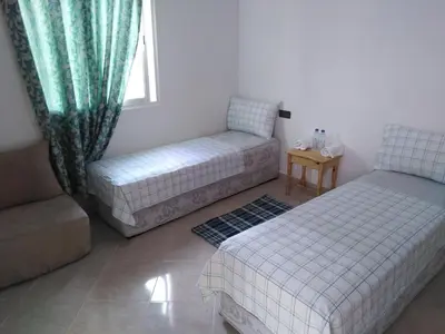 a living room with two beds and a couch at Dar Khalifa Airport in Nouaseur
