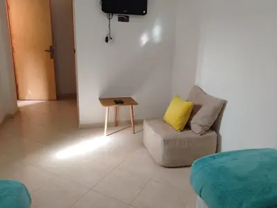 a living room with a couch and a table at Dar Khalifa Airport in Nouaseur