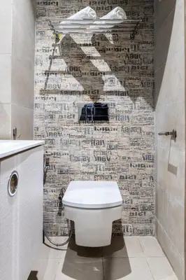 a bathroom with a toilet and a brick wall at Stylish & Chic Flat - Best Place - New Building in Casablanca