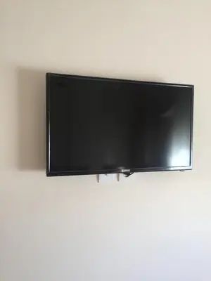 a flat screen tv hanging on a wall at ocean view apartment in Rabat
