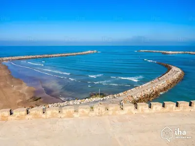 a walkway along the beach near the ocean at ocean view apartment in Rabat