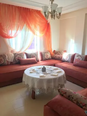 a living room with a red couch and a table at ocean view apartment in Rabat