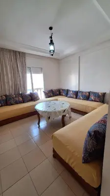 a living room with a couch and a table at ocean view apartment in Rabat