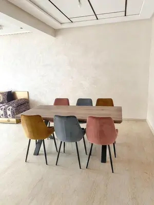 a table and four chairs in a room at Spacious apartment in Nouaseur of 167 m² in Nouaseur