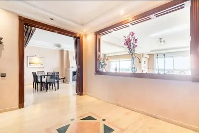 a living room with a large window and a dining room at Residence Elite appartement de luxe in Casablanca