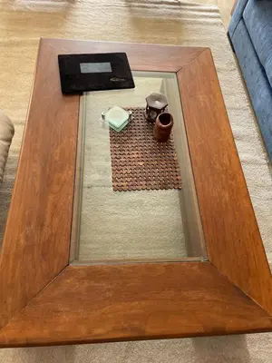 a wooden table with a glass top on the floor at Residence Elite appartement de luxe in Casablanca