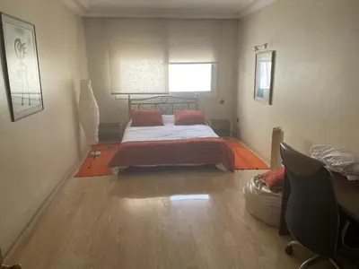 a bedroom with a bed and a window at Residence Elite appartement de luxe in Casablanca
