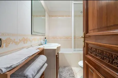 a bathroom with a sink and a toilet and a mirror at Residence Elite appartement de luxe in Casablanca