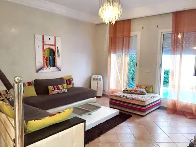 a living room with a couch and a table at Elegant villa in Dar Bouazza with year-round private pool in Dar Bouazza