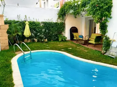 a swimming pool in the yard of a house at Elegant villa in Dar Bouazza with year-round private pool in Dar Bouazza
