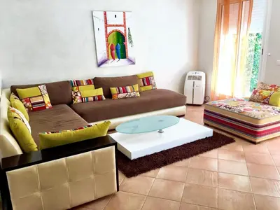 a living room with a couch and a coffee table at Elegant villa in Dar Bouazza with year-round private pool in Dar Bouazza
