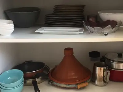 a kitchen shelf with dishes and a tea kettle at Dior D'Anfa in Casablanca
