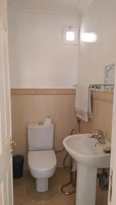a bathroom with a white toilet and a sink at Dior D'Anfa in Casablanca