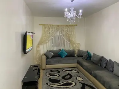a living room with a couch and a chandelier at Mohammed V International Airport HOUSE in Nouaseur