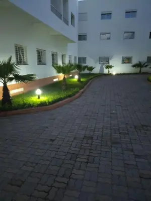a brick driveway in front of a building at night at Mohammed V International Airport HOUSE in Nouaseur