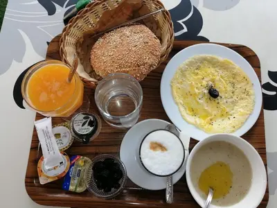 a tray of food with a basket of bread and other foods at Mohammed V International Airport HOUSE in Nouaseur
