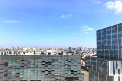 a tall glass building with a city in the background at Very beautiful apartment with see view 5th in Casablanca