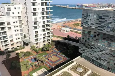 a view of a city with buildings and the ocean at Very beautiful apartment with see view 5th in Casablanca