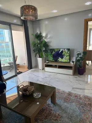a living room with a tv and a coffee table at Very beautiful apartment with see view 5th in Casablanca