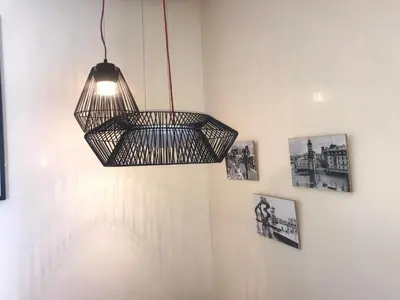 a hanging cage light fixture on a wall with pictures at Charming Appartement With a Beautifull View 41 in Casablanca