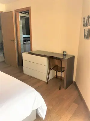 a bedroom with a desk and a chair next to a bed at Charming Appartement With a Beautifull View 41 in Casablanca