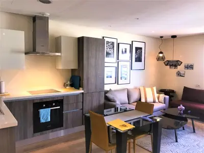 a kitchen and living room with a couch and a table at Charming Appartement With a Beautifull View 41 in Casablanca