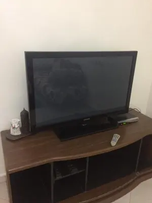 a flat screen tv sitting on a wooden stand at Home Sweet Home Just a 2-Minute Walk to the Tram