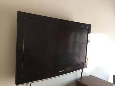 a flat screen tv sitting on a wall at Home Sweet Home Just a 2-Minute Walk to the Tram