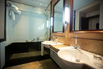 a bathroom with two sinks and a large mirror at Hotel Atlantic Agdal in Rabat