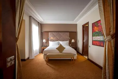 a hotel room with a bed and a window at Hotel Atlantic Agdal in Rabat