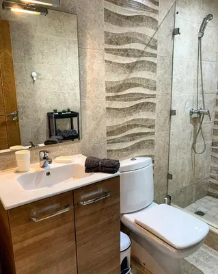 a bathroom with a toilet and a sink and a shower at Magnifique Appart a Savannah Beach in Sidi Rahal