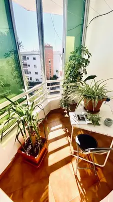 a balcony with plants and a table and a chair at Modern & Sunny new appartement 2 rooms in Rabat centre - Hay Riad in Rabat