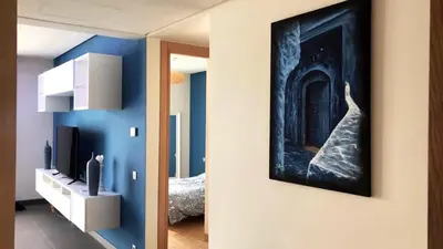 a room with a blue wall with a painting on the wall at Luxury Anfaplace Living Resort in Casablanca