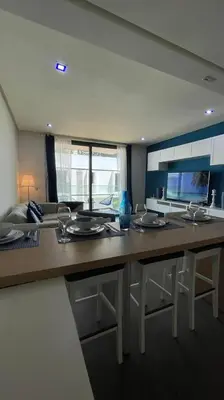 a kitchen with a long counter with plates on it at Luxury Anfaplace Living Resort in Casablanca