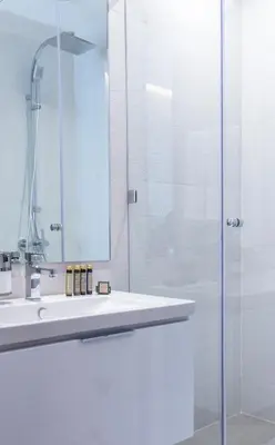 a bathroom with a sink and a glass shower at Makass Appart Hotel in Rabat