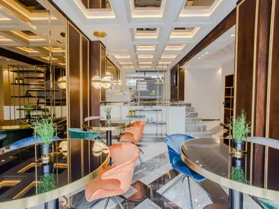 a restaurant with glass tables and blue chairs at Makass Appart Hotel in Rabat