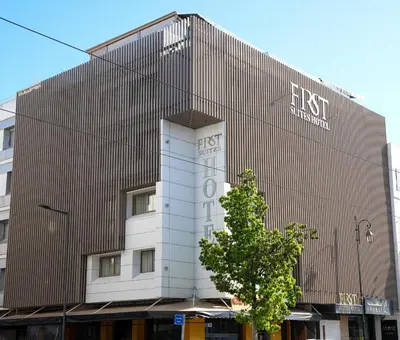 a building with a sign on the side of it at First Suites Hôtel in Rabat