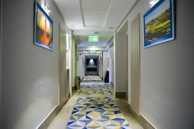 a hallway with a tile floor in a building at Gardenia Boutique Hotel in Rabat