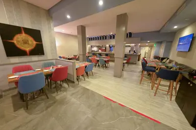 a dining room with tables and chairs in a restaurant at Gardenia Boutique Hotel in Rabat