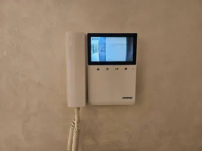 a phone hanging on a wall with a cord at Très bel appartement en face du parc, près du Novotel in Mohammedia