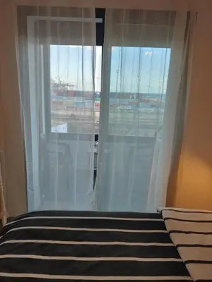 a bedroom with a window with white curtains at Atlantic studio in Atlantic Plaza with Free parking , Available public bus to,from casa port station and downtown in Casablanca