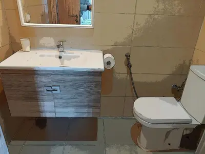 a bathroom with a sink and a toilet and a mirror at Atlantic studio in Atlantic Plaza with Free parking , Available public bus to,from casa port station and downtown in Casablanca