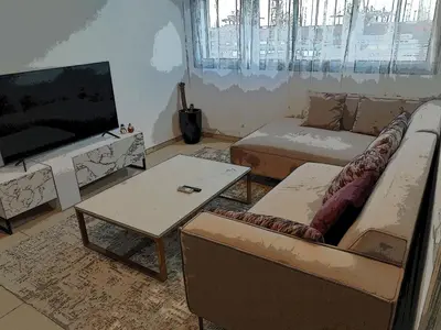 a living room with a tv and a couch and a table at Atlantic studio in Atlantic Plaza with Free parking , Available public bus to,from casa port station and downtown in Casablanca