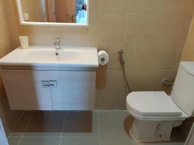 a bathroom with a sink and a toilet and a mirror at Atlantic studio in Atlantic Plaza with Free parking , Available public bus to,from casa port station and downtown in Casablanca