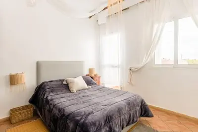 a bedroom with a large bed in a room with a window at Sea view Tamaris Dar Bouazza in Tamaris
