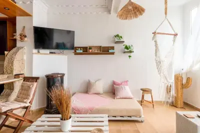a living room with a bed and a tv at Sea view Tamaris Dar Bouazza in Tamaris