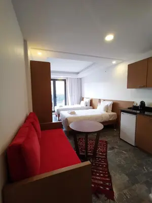 a living room with a couch and a bed and a table at Casa City Break Appart hôtel in Casablanca