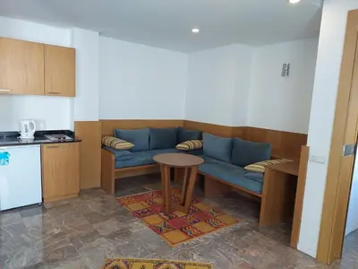 a living room with a blue couch and a table at Casa City Break Appart hôtel in Casablanca