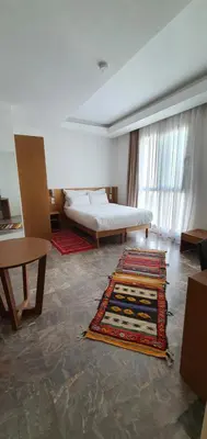 a living room with a bed and a rug at Casa City Break Appart hôtel in Casablanca