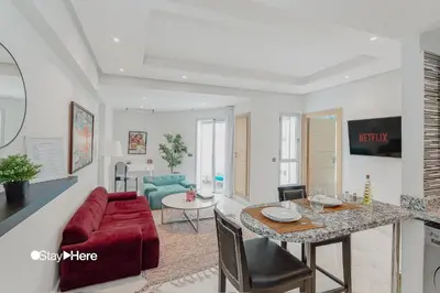 a living room with a red couch and a table at Stayhere Rabat - Agdal 2 - Classic Residence in Rabat